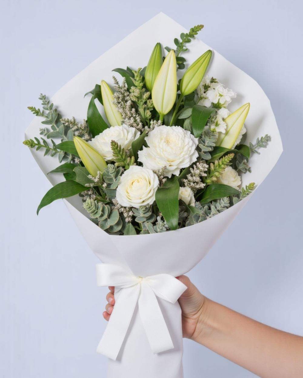 white flower bouquet with white roses and lilies.
