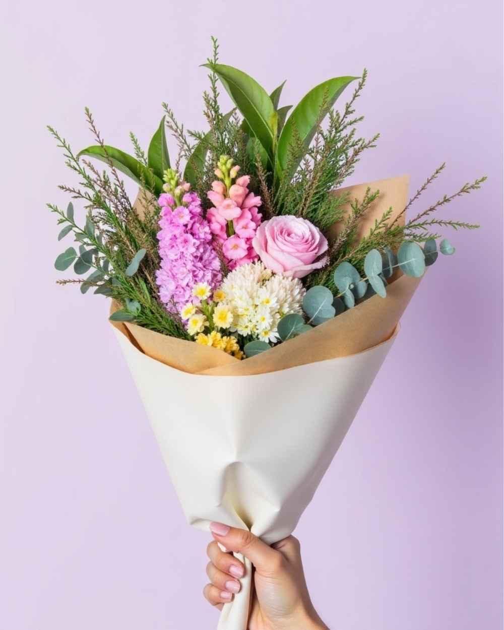 Small, colourful flower posy featuring 2 snapdragons, one rose and greenery.