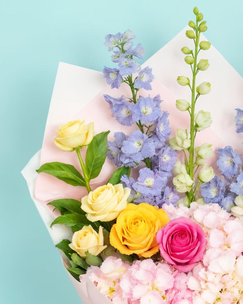 Pastel Bouquet closeup showing roses, snapdragons and hydrangeas.